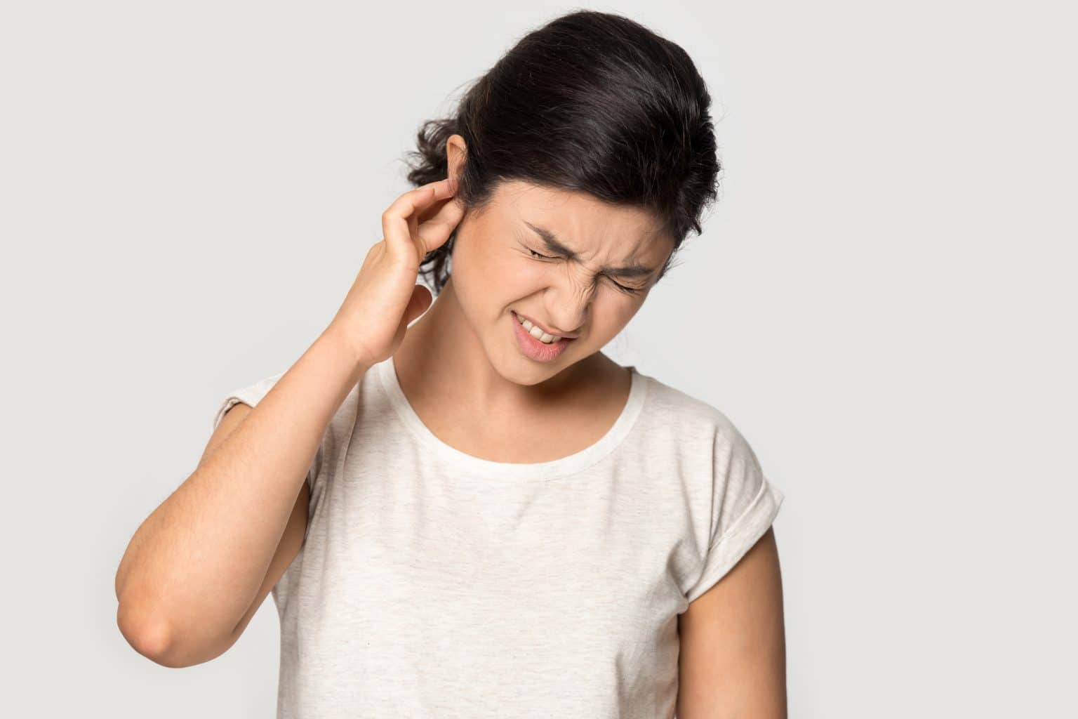 Woman Holding Ear Due to Cholesteatoma